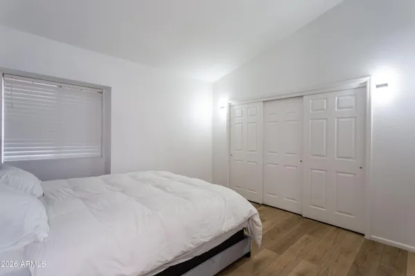 a bedroom with a bed and a window