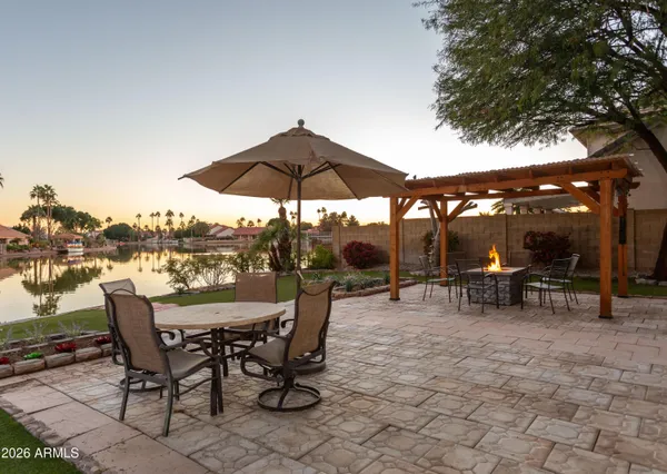 a view of a tables and chairs under an umbrella in the patio