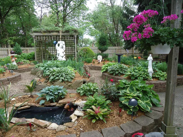 a small garden and covered with tall trees