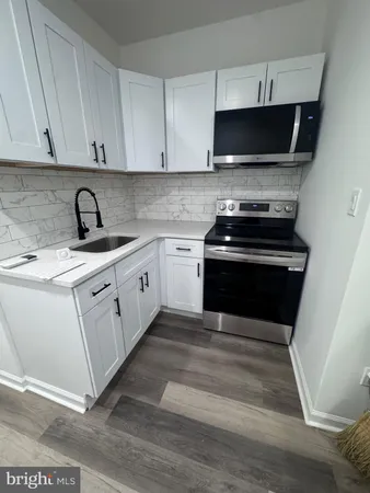 a kitchen with a stove and a microwave