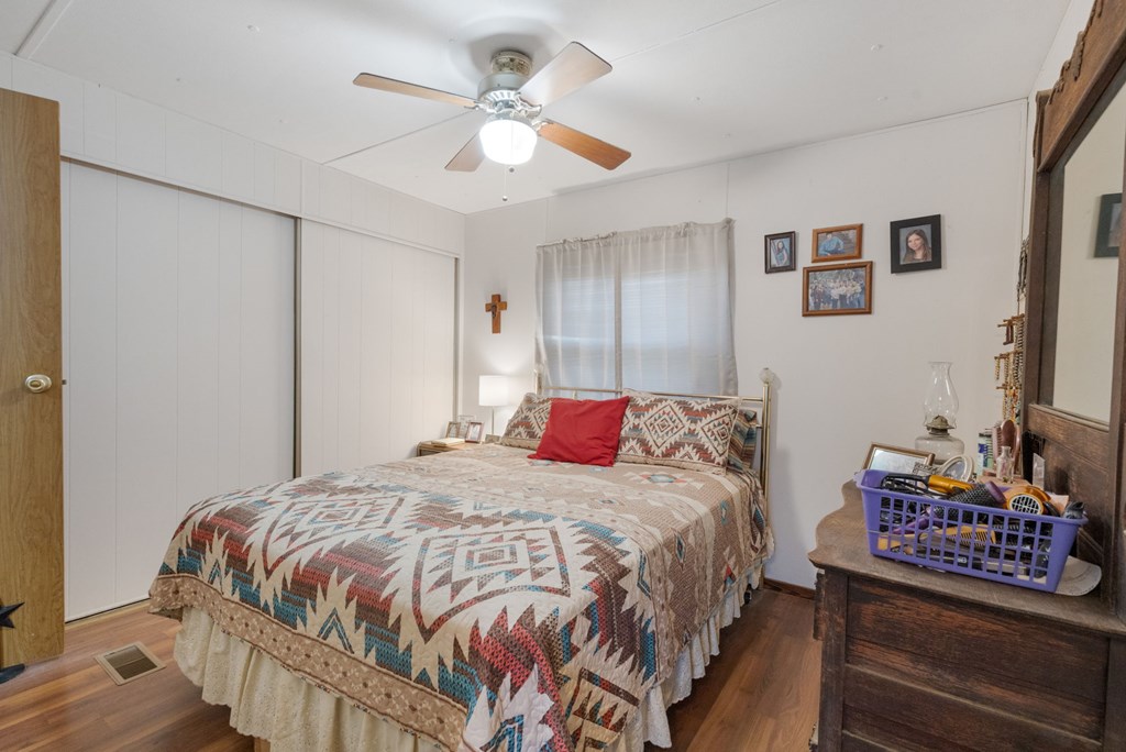 73 Fm 1221 Hext, TX 76848 - Photo 21 of 27 a bedroom with a bed a rug and a chandelier
