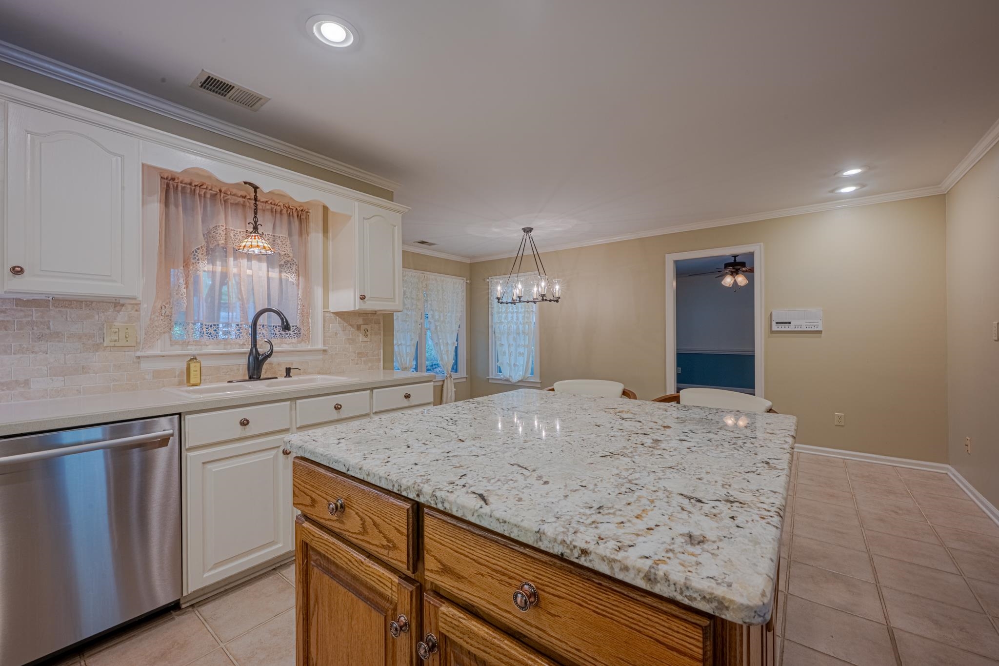 8805 River Rise Drive Memphis, TN 38016 - Photo 13 of 40 a kitchen with granite countertop sink and cabinets