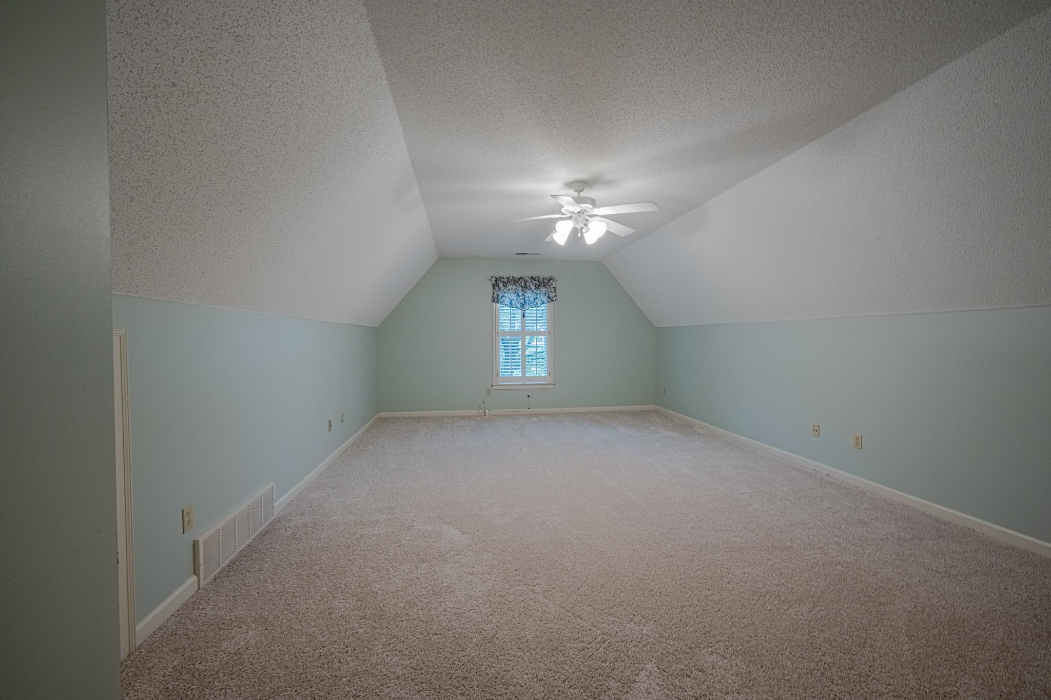 8805 River Rise Drive Memphis, TN 38016 - Photo 27 of 40 a view of an empty room with window and chandelier fan