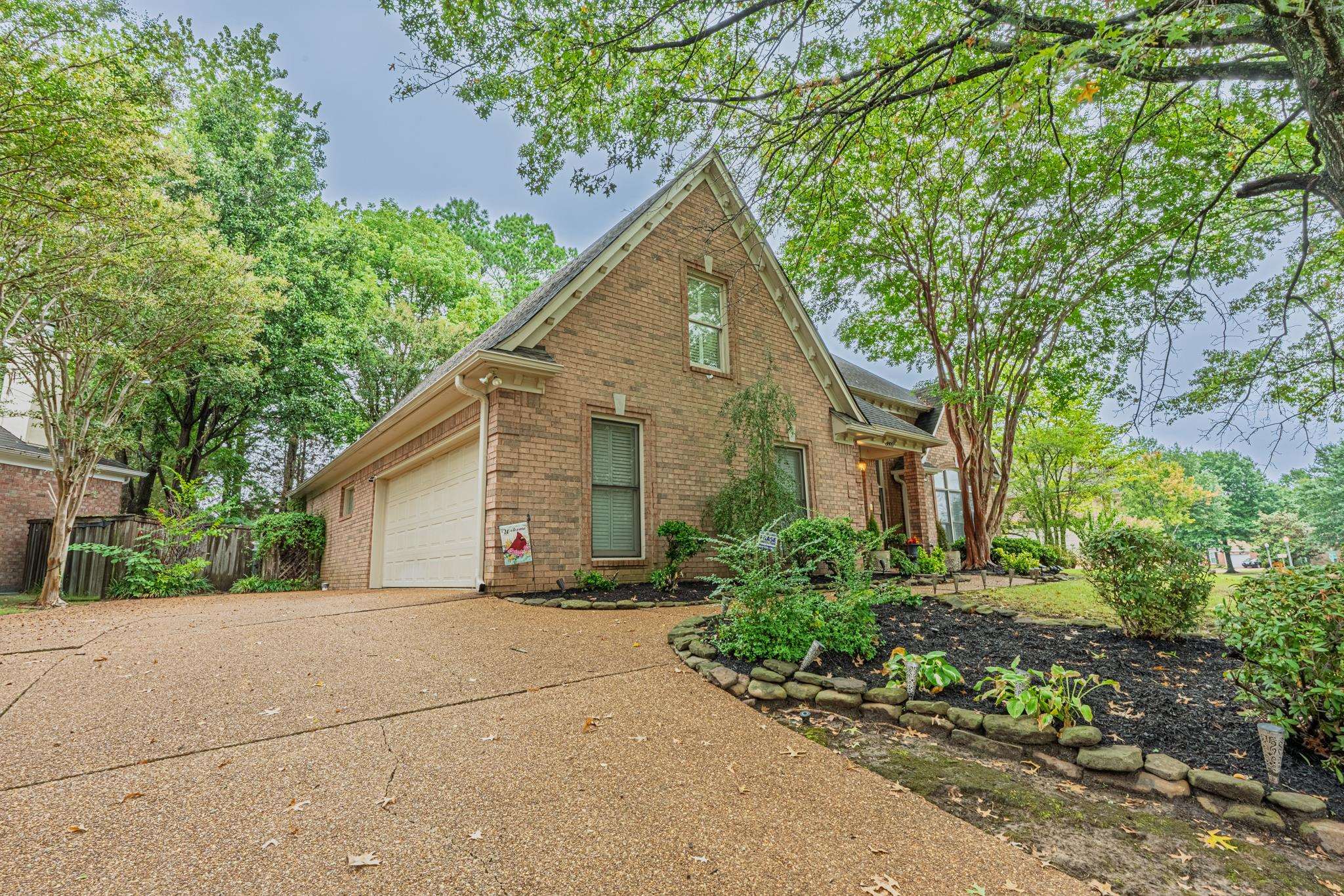8805 River Rise Drive Memphis, TN 38016 - Photo 40 of 40 a view of a house with a small yard plants and large tree