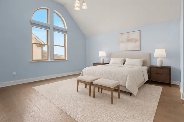 a bedroom with a bed a table and painting