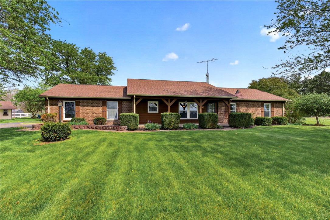 7988 McCool Road Greenville, OH 45331 - Photo 1 of 50 This ranch-style home features classic brick construction, a warm wood facade, and a neatly manicured lawn.