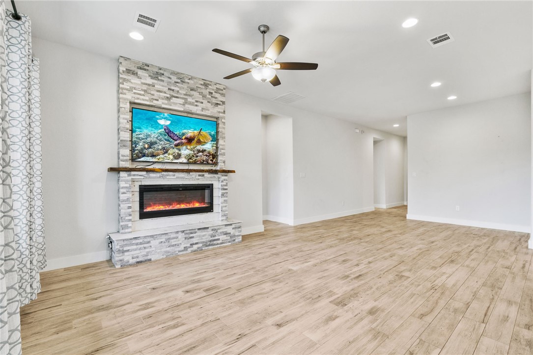 941 Del Raphael Drive Leander, TX 78641 - Photo 6 of 33 The built-in electric fireplace gives the room an immediate focal point and a cozy spot to unwind when the weather cools down