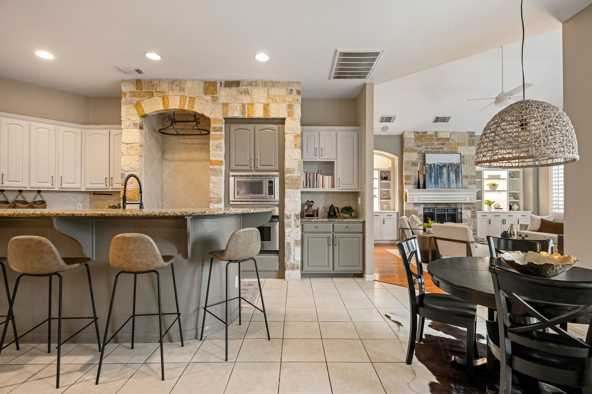 10804 Ariock Lane Austin, TX 78739 - Photo 8 of 32 a kitchen with stainless steel appliances kitchen island granite countertop a table and chairs in it