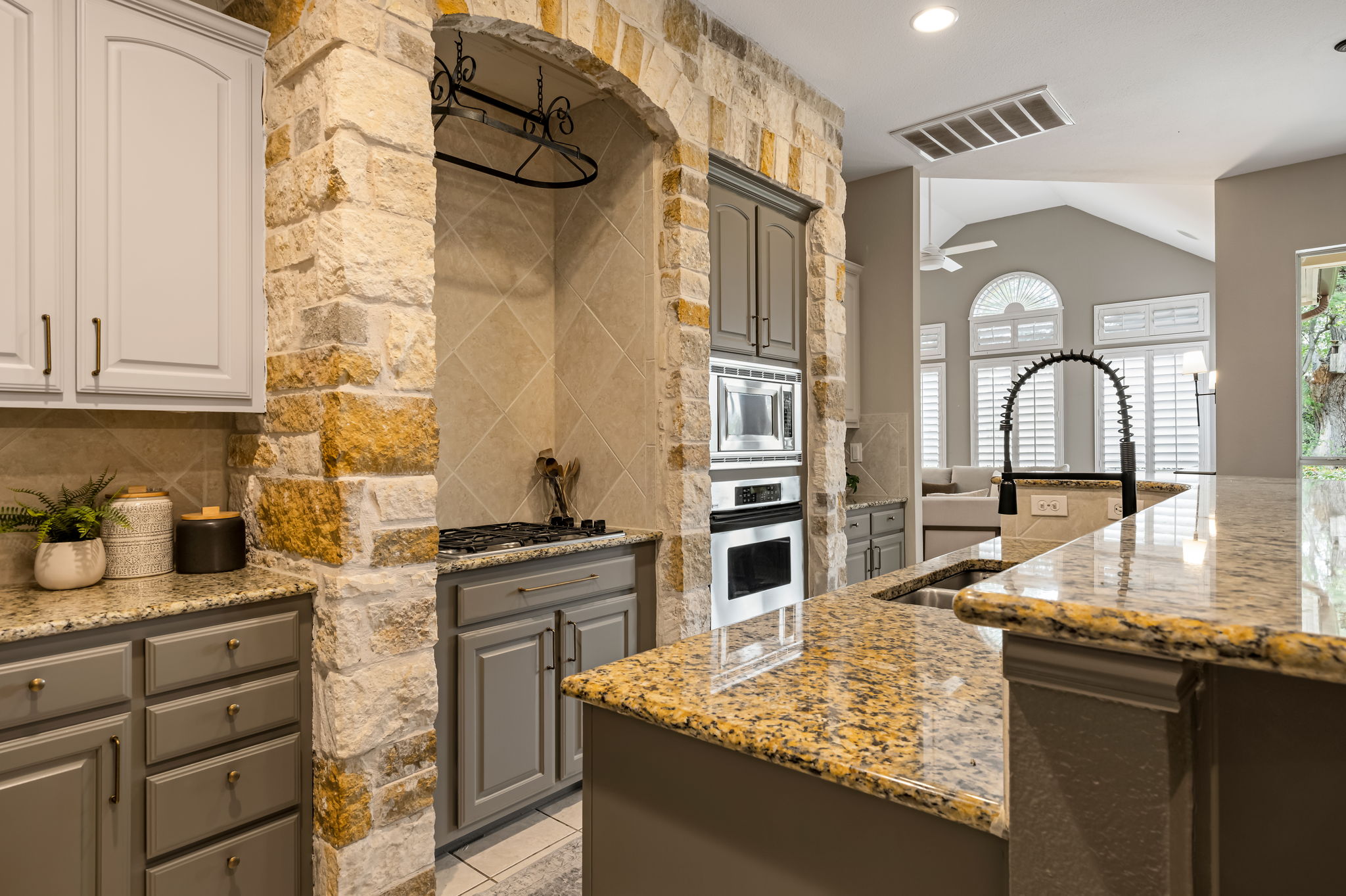 10804 Ariock Lane Austin, TX 78739 - Photo 9 of 32 a kitchen with granite countertop a stove and a sink