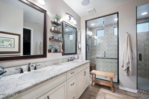 a bathroom with a granite countertop sink and a mirror