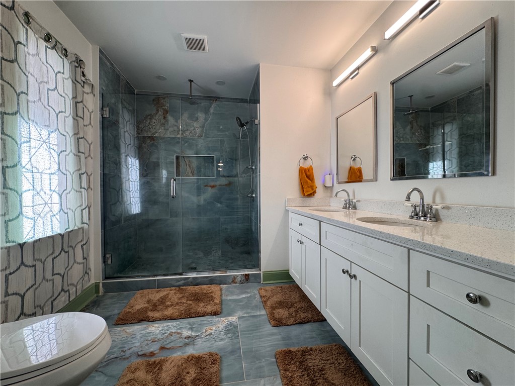 2211 East River Street Anderson, SC 29621 - Photo 40 of 40 This primary bathroom features a double vanity and a spacious walk-in shower.