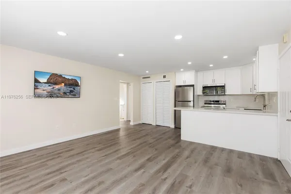 a view of kitchen with wooden floor