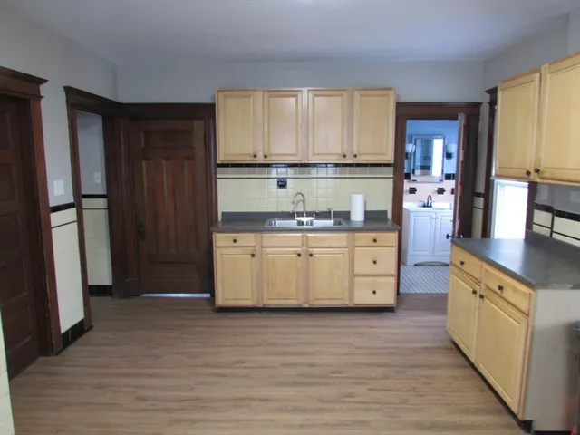 a kitchen with a white stove top oven and refrigerator
