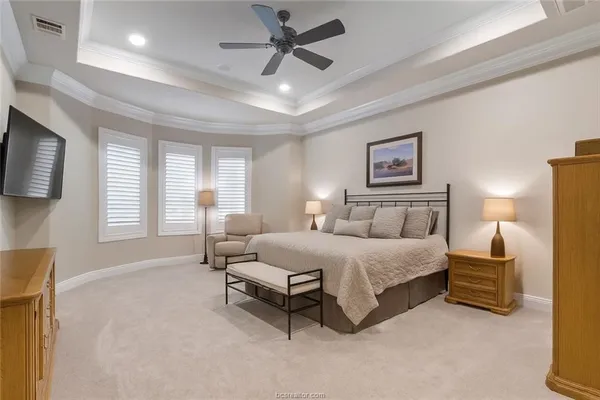 a spacious bedroom with a bed and a couch