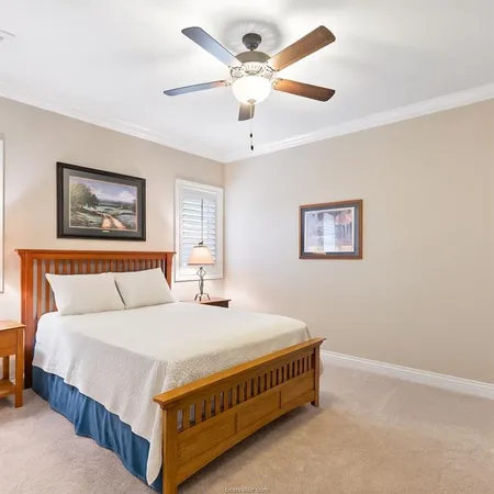a bed sitting in a bedroom and a chandelier