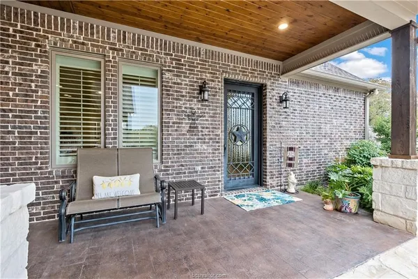 a balcony with furniture and flowers