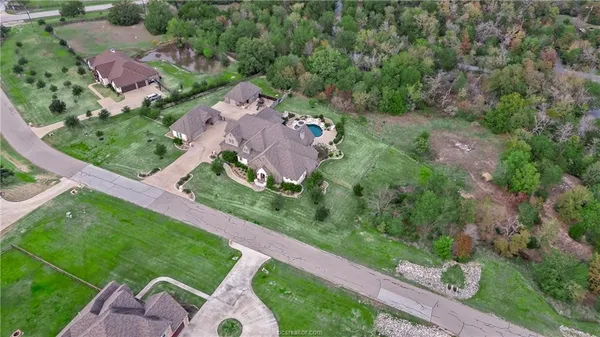 an aerial view of a house with a yard