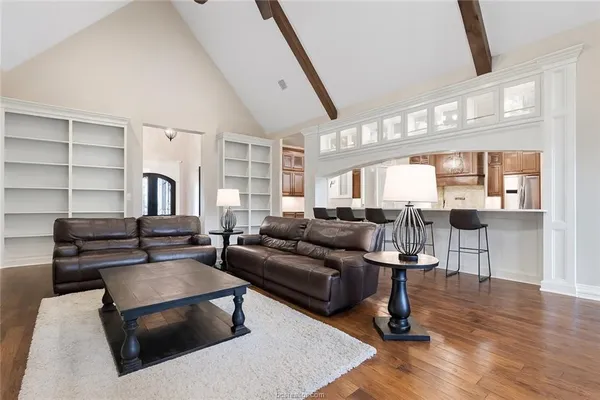 a living room with furniture and wooden floor