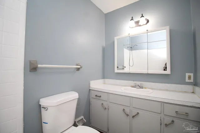 a bathroom with a sink toilet and mirror