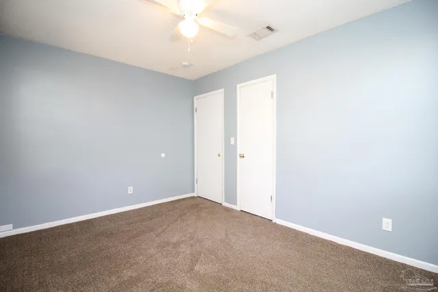a view of an empty room with a fan