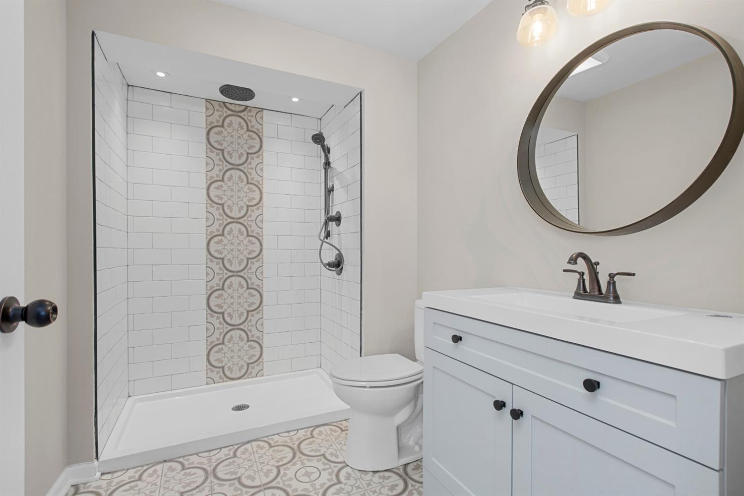 283 West Division Road Valparaiso, IN 46385 - Photo 11 of 17 a bathroom with a sink toilet a mirror and shower