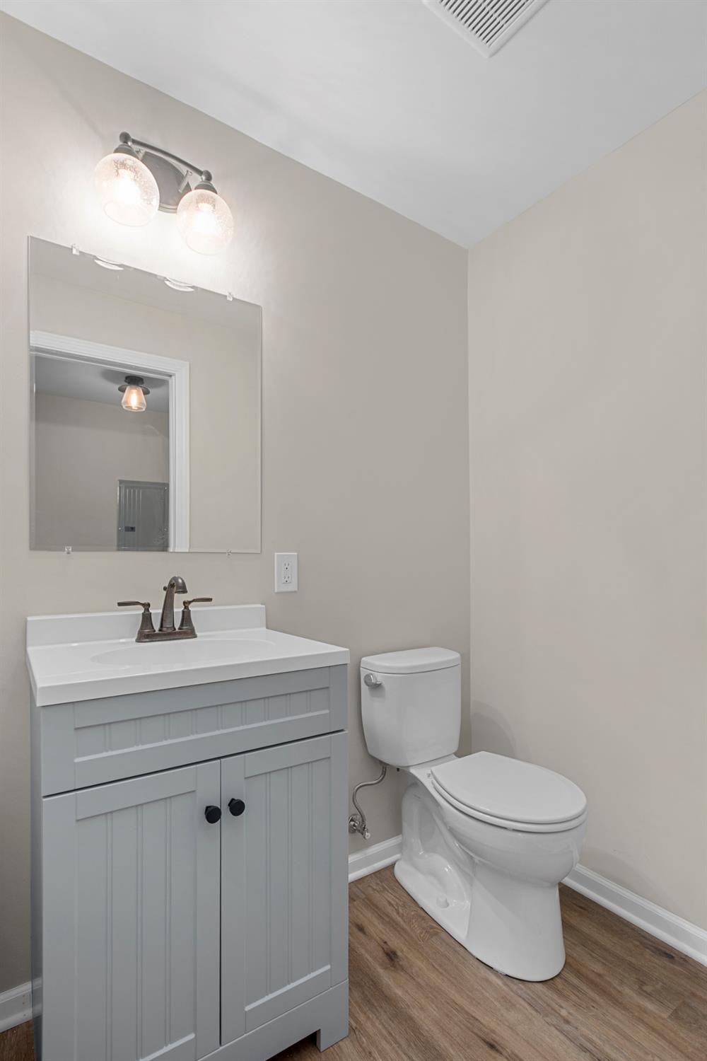 283 West Division Road Valparaiso, IN 46385 - Photo 8 of 17 a bathroom with a toilet a sink and mirror