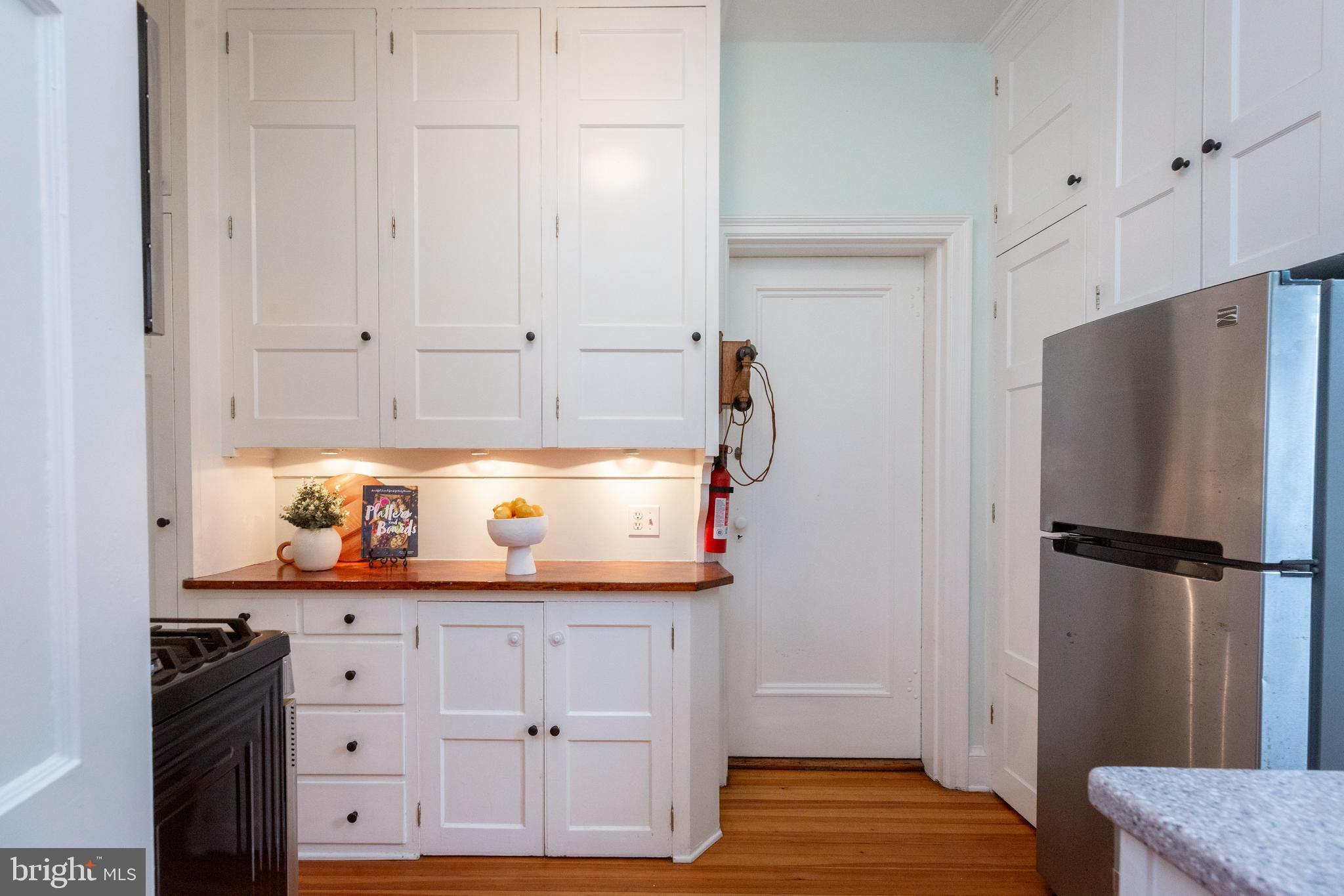3900 Connecticut Avenue Northwest, Unit 306F Washington, DC 20008 - Photo 12 of 33 a kitchen with stainless steel appliances granite countertop a refrigerator and a stove