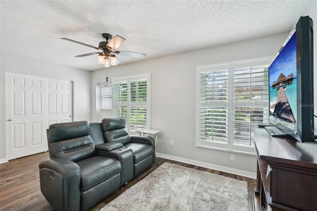 2255 Philippine Drive, Unit 9 Clearwater, FL 33763 - Photo 11 of 47 a living room with furniture a flat screen tv and a window