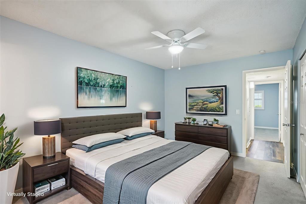 2255 Philippine Drive, Unit 9 Clearwater, FL 33763 - Photo 16 of 47 a bedroom with a bed and a chandelier