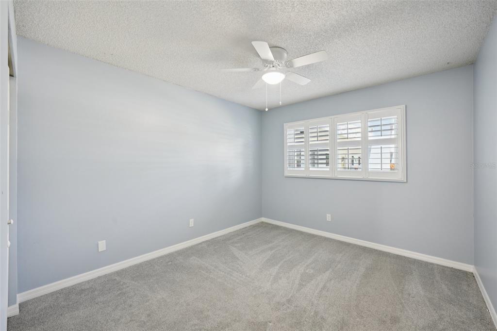 2255 Philippine Drive, Unit 9 Clearwater, FL 33763 - Photo 21 of 47 an empty room with a window and a fan