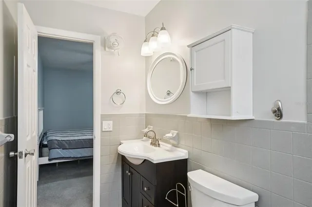 a bathroom with a sink a toilet and a mirror