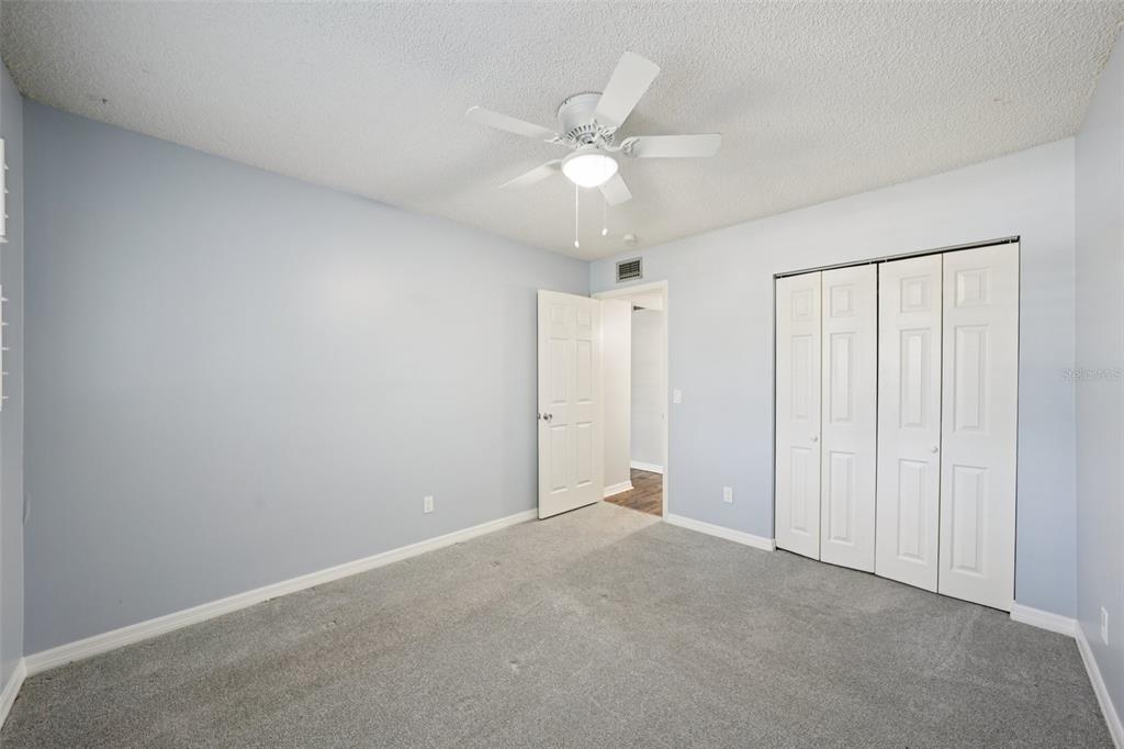 2255 Philippine Drive, Unit 9 Clearwater, FL 33763 - Photo 23 of 47 an empty room with a ceiling fan and a window