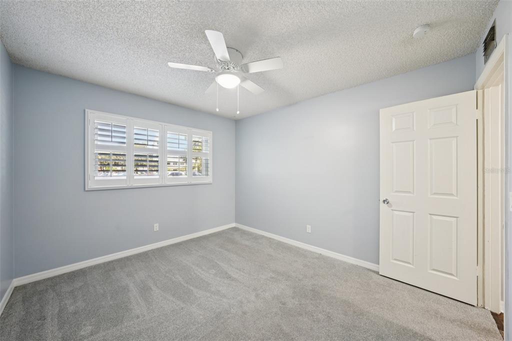 2255 Philippine Drive, Unit 9 Clearwater, FL 33763 - Photo 24 of 47 an empty room with a window and a fan