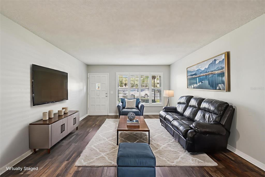 2255 Philippine Drive, Unit 9 Clearwater, FL 33763 - Photo 7 of 47 a living room with furniture and a flat screen tv