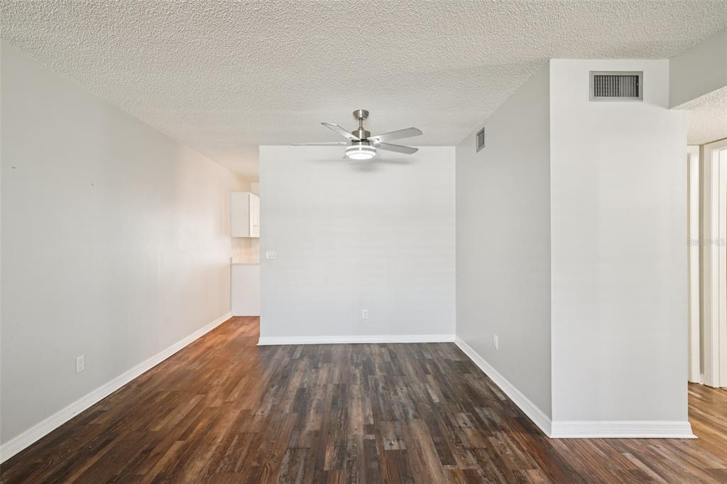 2255 Philippine Drive, Unit 9 Clearwater, FL 33763 - Photo 9 of 47 an empty room with wooden floor and a ceiling fan
