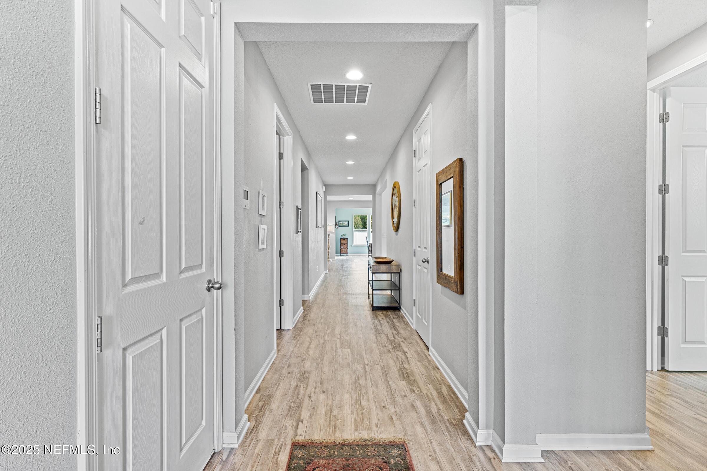 463 Tumbled Stone Way St. Augustine, FL 32086 - Photo 16 of 71 a view of a hallway with a livingroom and a bathroom with sink