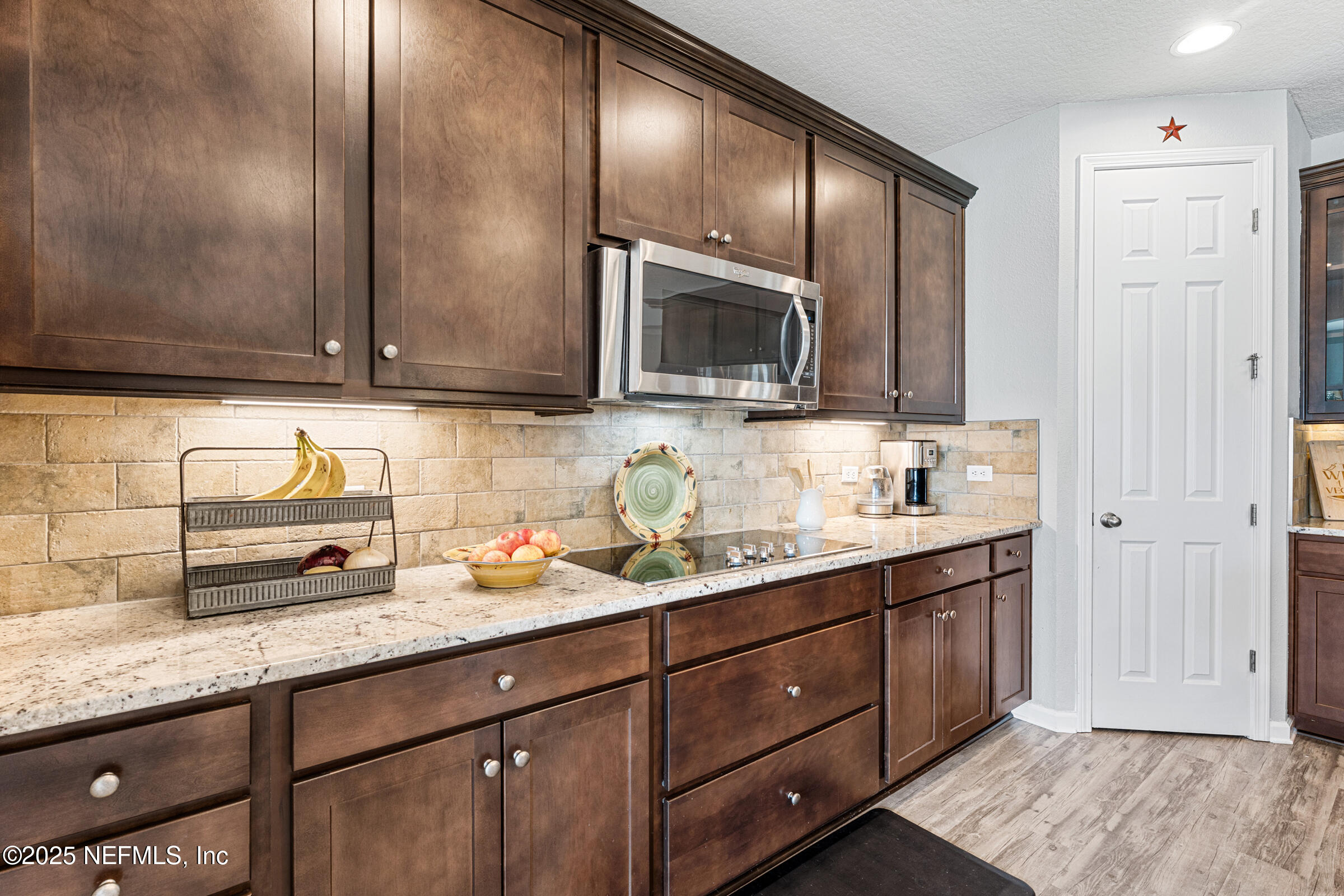 463 Tumbled Stone Way St. Augustine, FL 32086 - Photo 20 of 71 a kitchen with stainless steel appliances granite countertop a sink stove and cabinets