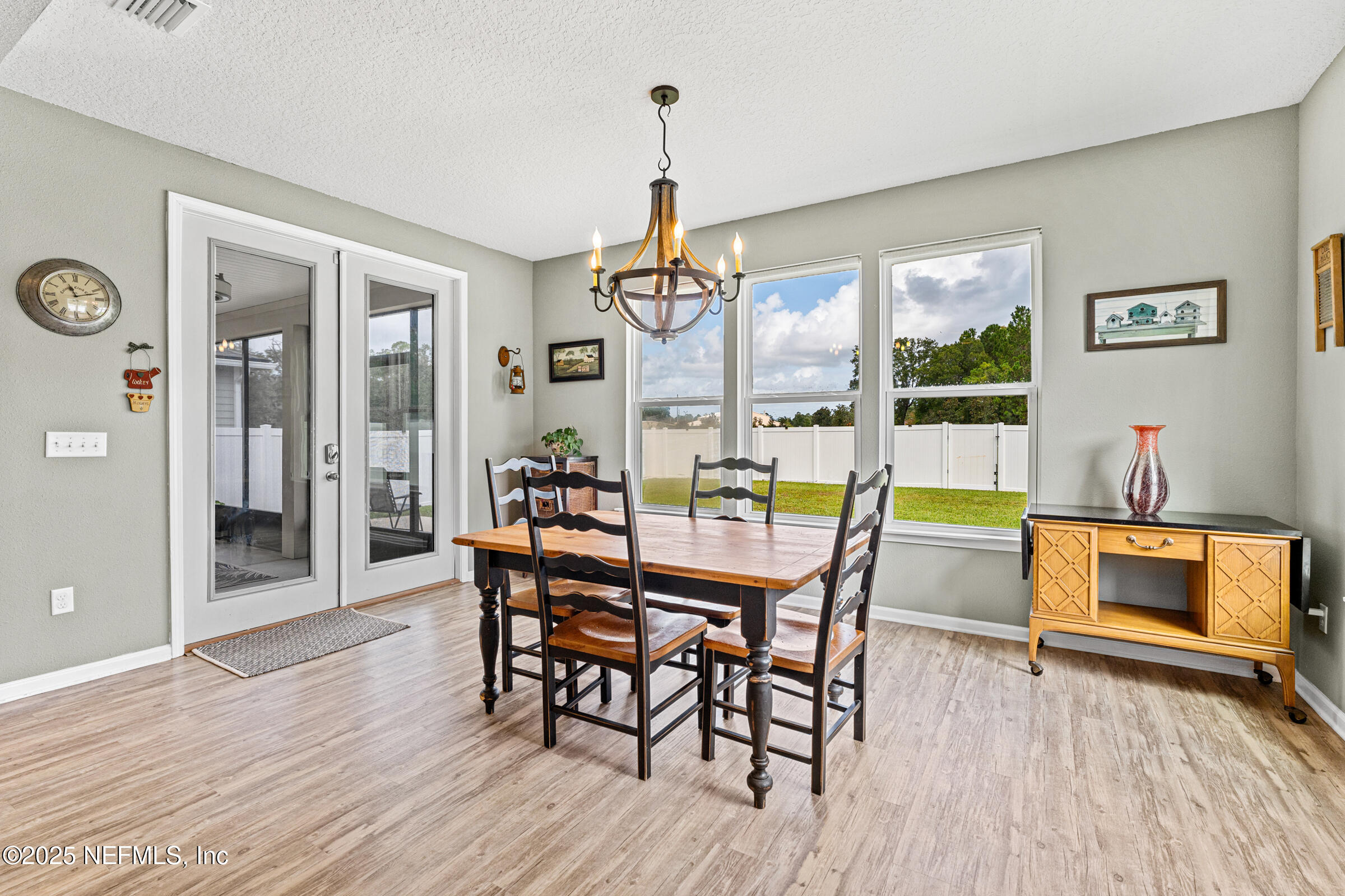 463 Tumbled Stone Way St. Augustine, FL 32086 - Photo 23 of 71 a dining room with furniture a chandelier and wooden floor