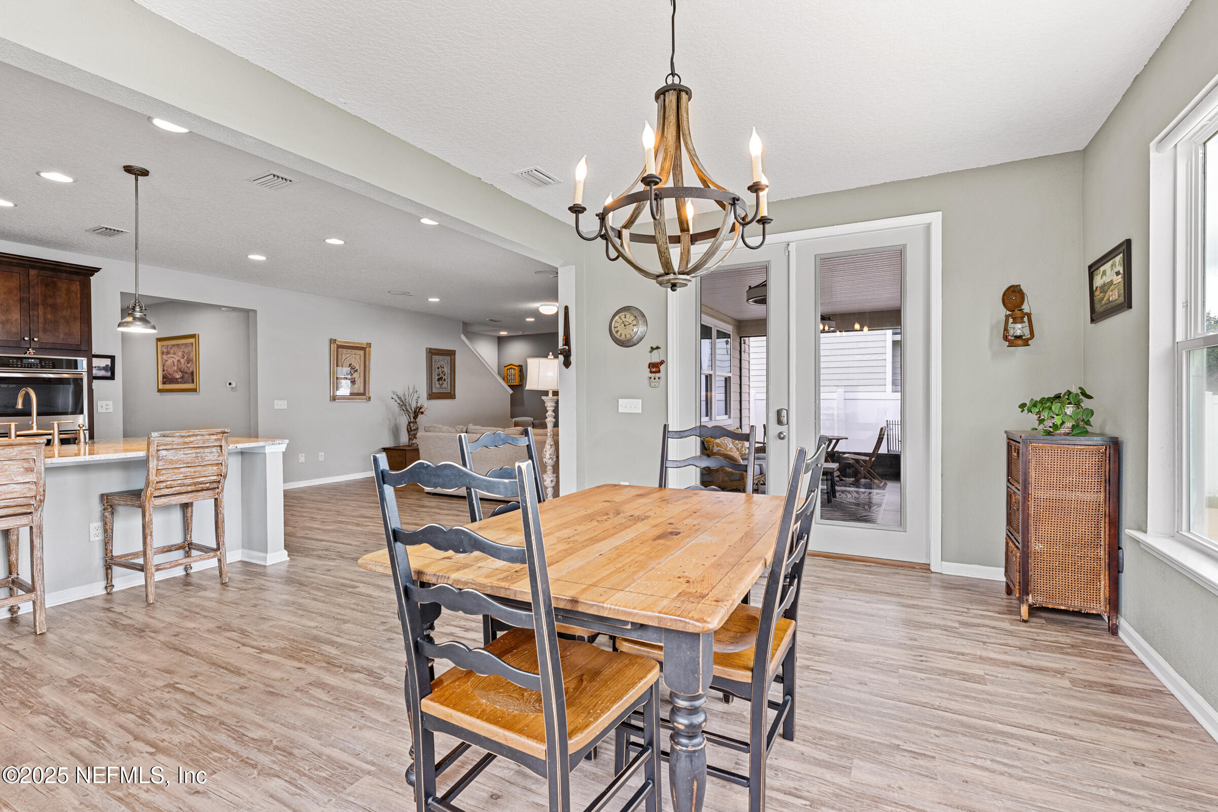 463 Tumbled Stone Way St. Augustine, FL 32086 - Photo 24 of 71 a view of a dining room with furniture and wooden floor