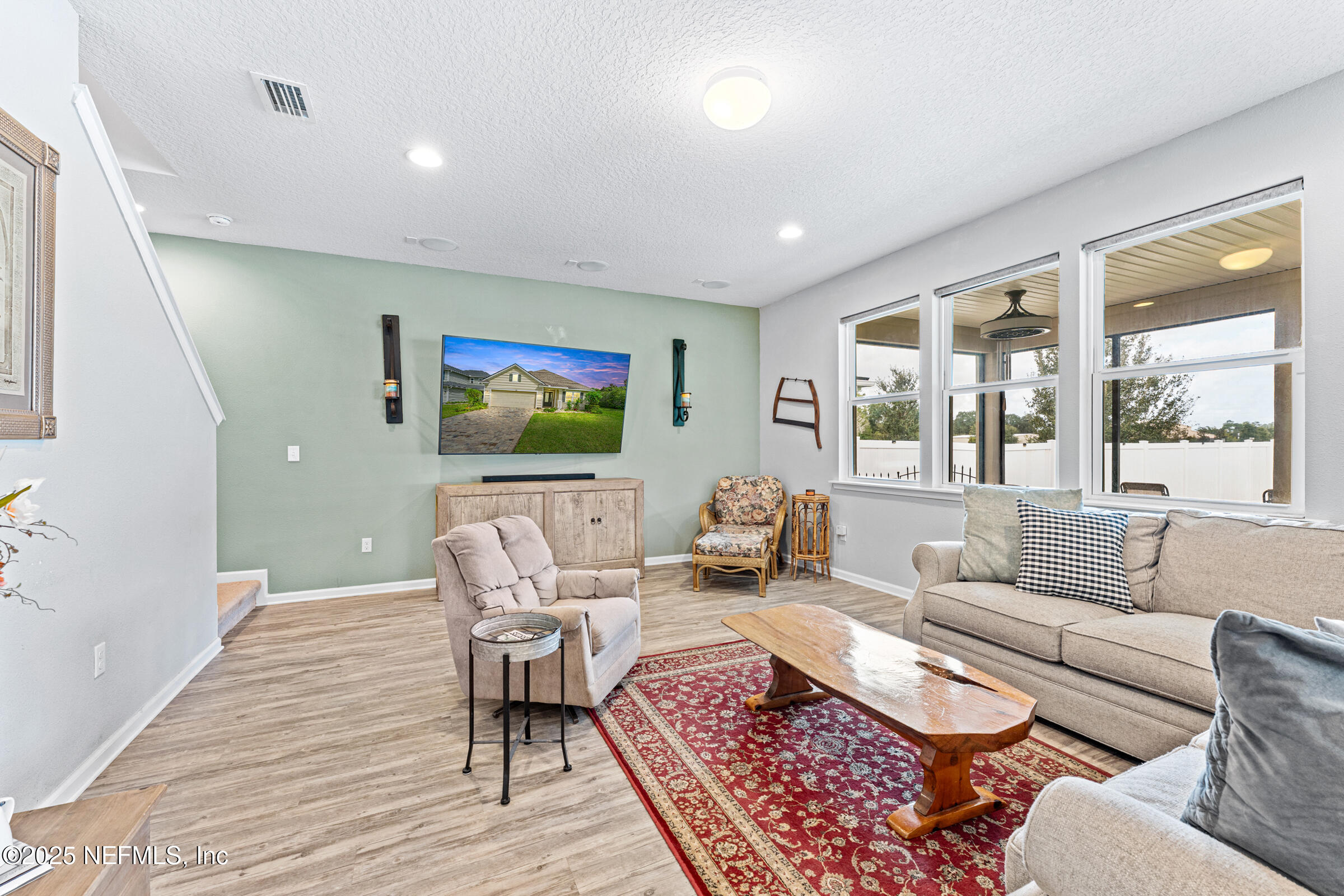 463 Tumbled Stone Way St. Augustine, FL 32086 - Photo 32 of 71 a living room with furniture and a flat screen tv