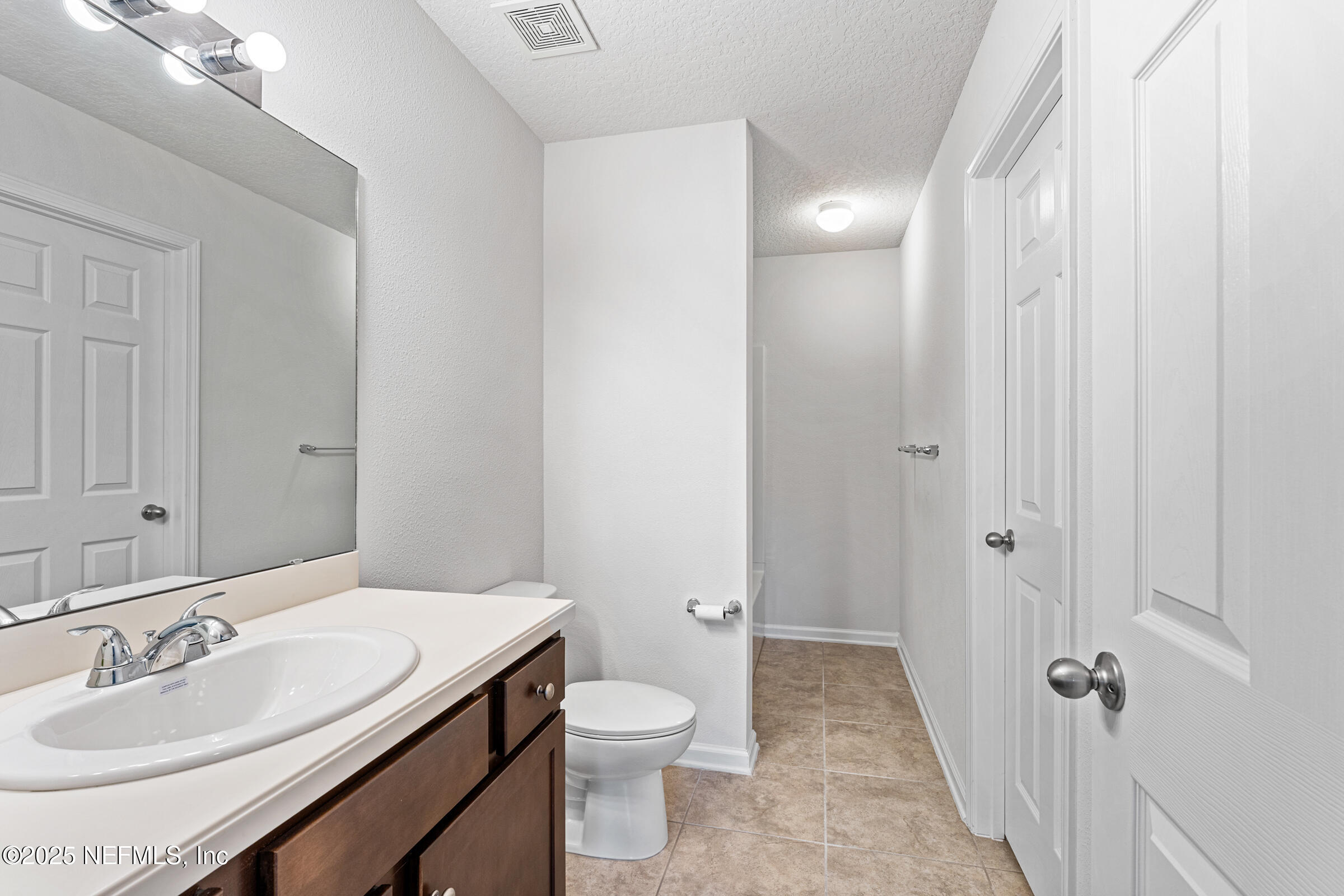 463 Tumbled Stone Way St. Augustine, FL 32086 - Photo 37 of 71 a bathroom with a sink a toilet and shower