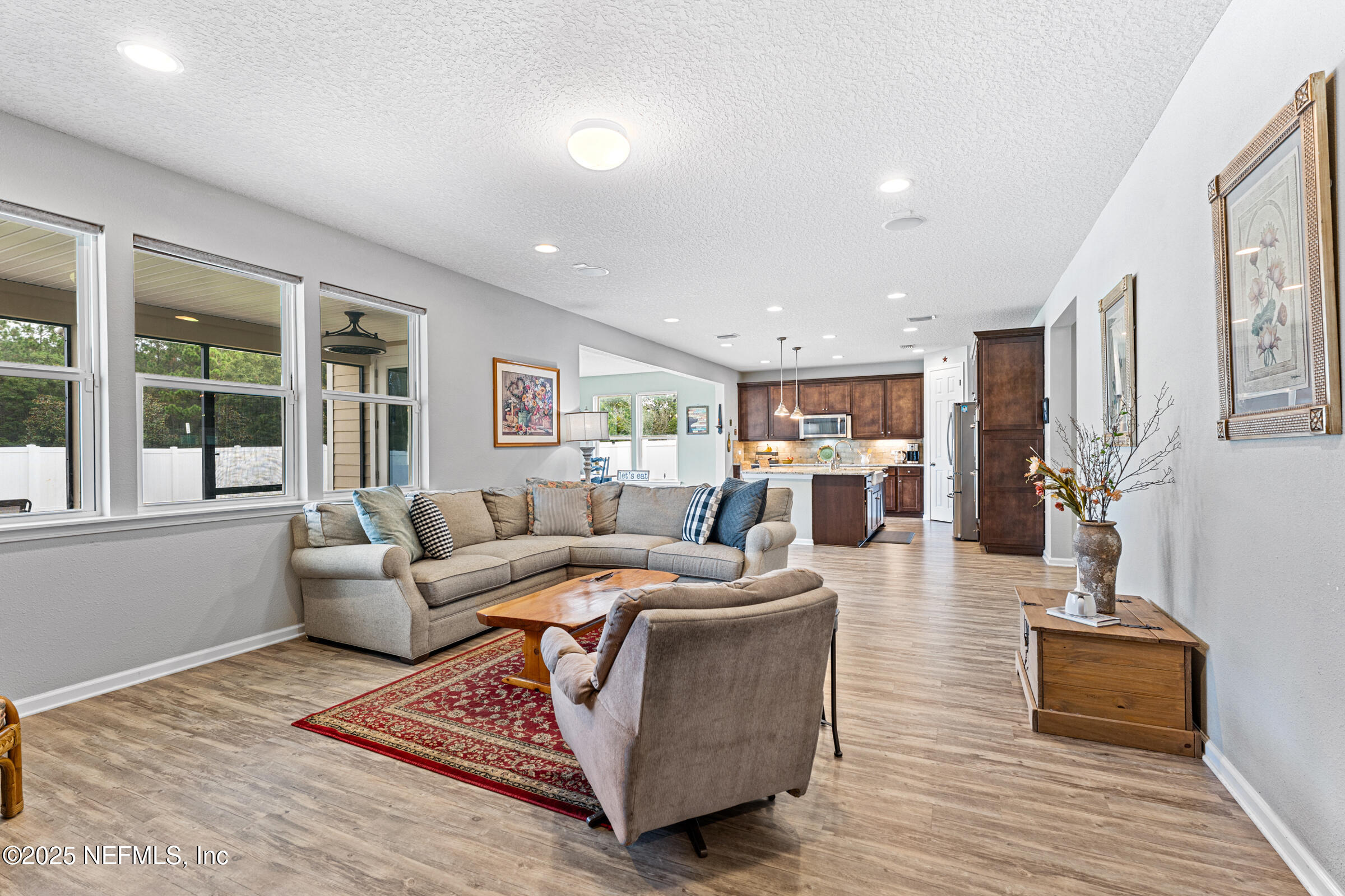 463 Tumbled Stone Way St. Augustine, FL 32086 - Photo 38 of 71 a living room with furniture and wooden floor