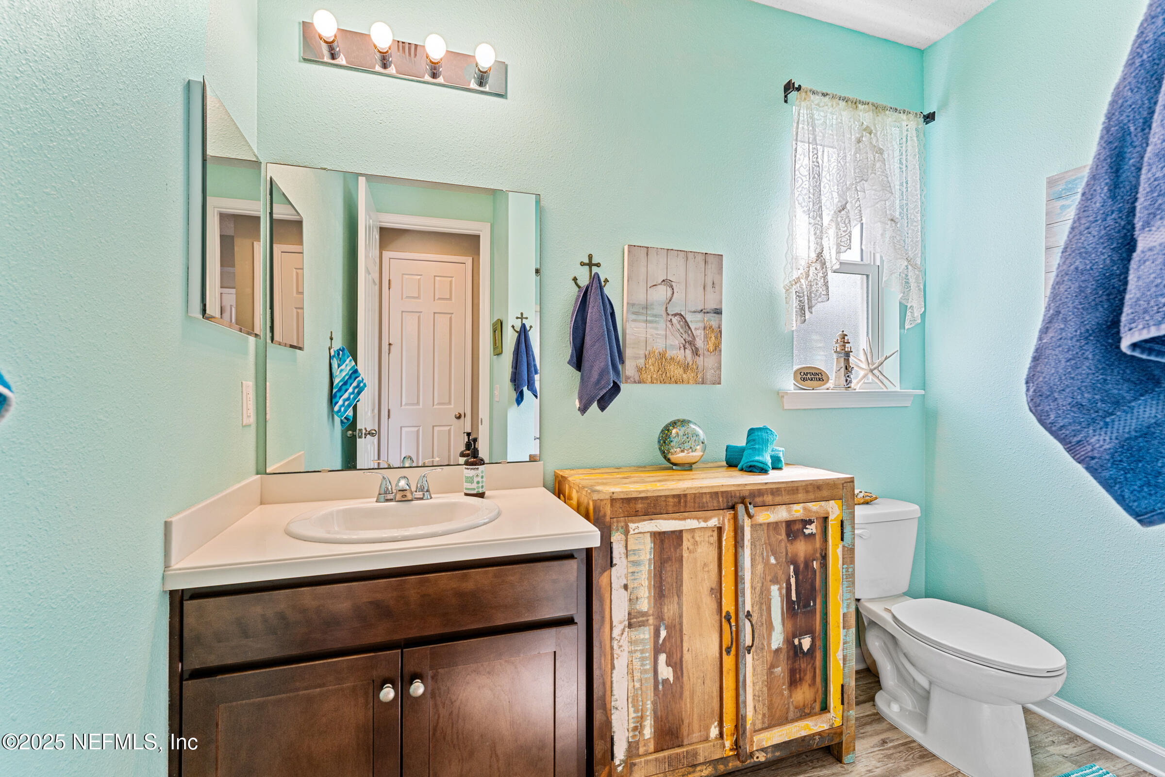 463 Tumbled Stone Way St. Augustine, FL 32086 - Photo 47 of 71 a bathroom with a sink a toilet and mirror