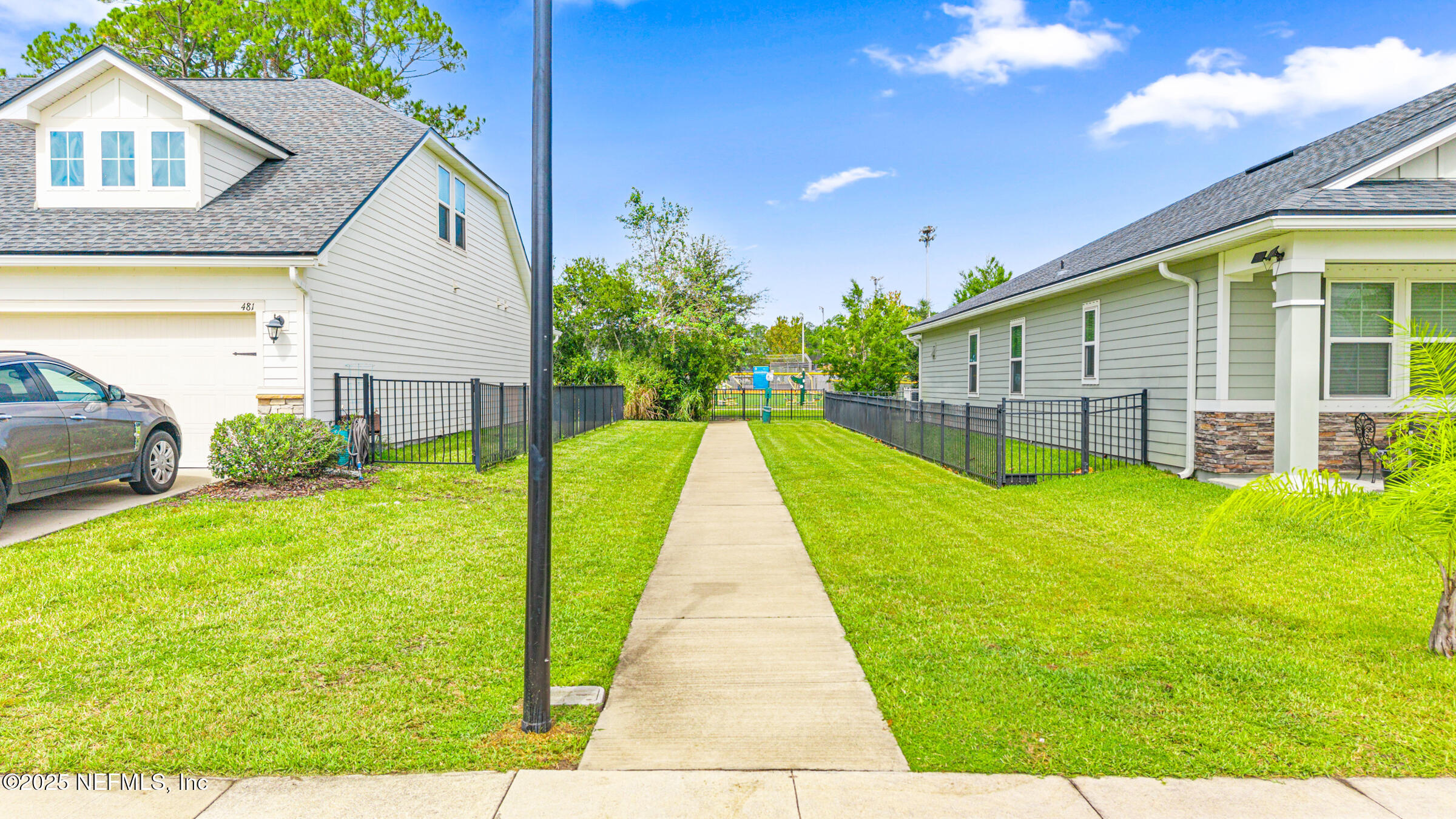 463 Tumbled Stone Way St. Augustine, FL 32086 - Photo 65 of 71 a view of a backyard with table and chairs and wooden fence