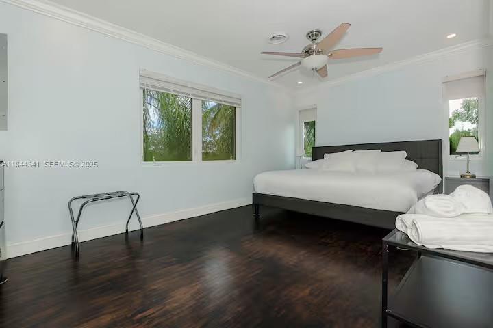 7475 Southwest 134th Street Pinecrest, FL 33156 - Photo 15 of 42 a bedroom with a bed and a chandelier