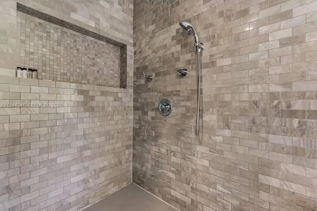 a bathroom with a sink mirror and a bathtub next to a window
