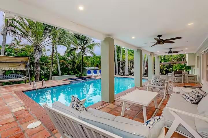 7475 Southwest 134th Street Pinecrest, FL 33156 - Photo 2 of 42 a view of a patio with couches table and chairs with potted plants and large tree