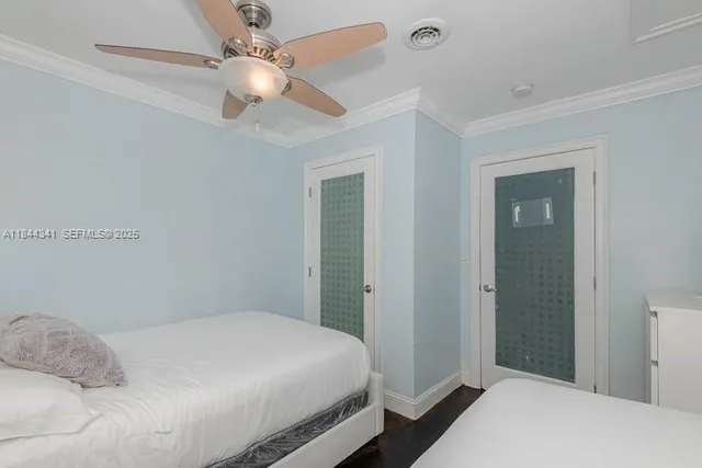 a bedroom with a bed and a painting on the wall