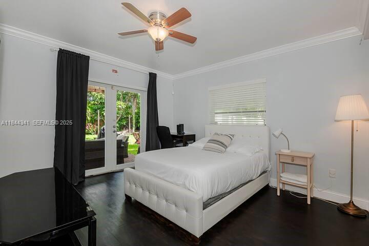 7475 Southwest 134th Street Pinecrest, FL 33156 - Photo 24 of 42 a bedroom with a bed and a large window