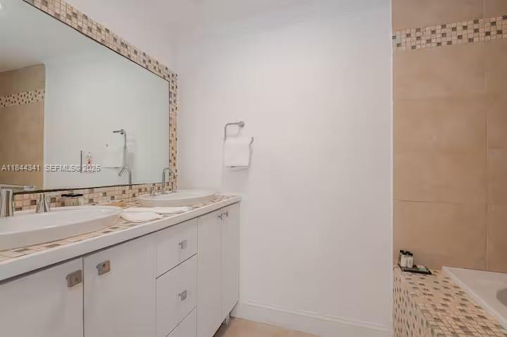 7475 Southwest 134th Street Pinecrest, FL 33156 - Photo 25 of 42 a bathroom with a sink and a mirror
